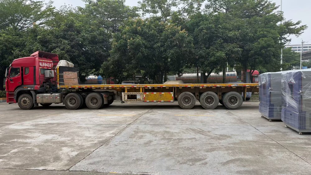 Empty flatbed trailer waiting on the yard at the Derui Testing plant in Dongguan before the seven test chambers were loaded