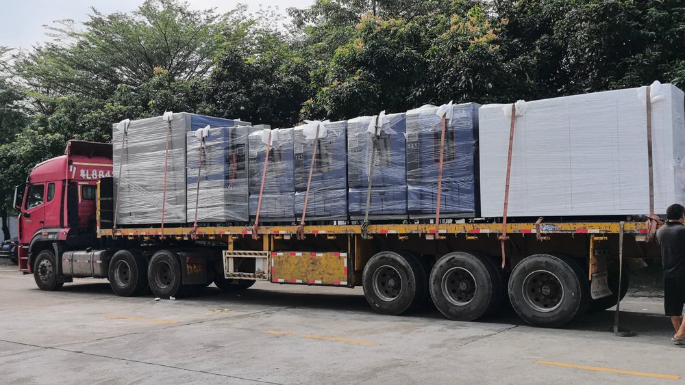 Seven environmental test chambers wrapped in protective film and secured with straps on the flatbed trailer at the Derui Testing plant